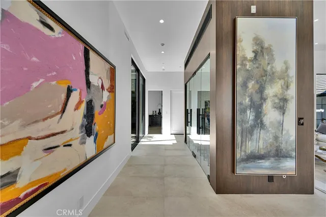 a view of a hallway with paintings on the wall