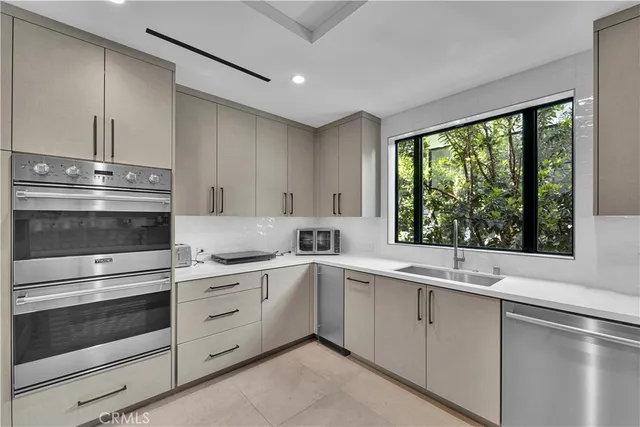 a kitchen with a stove and white cabinets