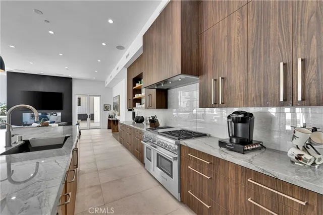 a kitchen with stainless steel appliances a stove a sink a microwave and cabinets