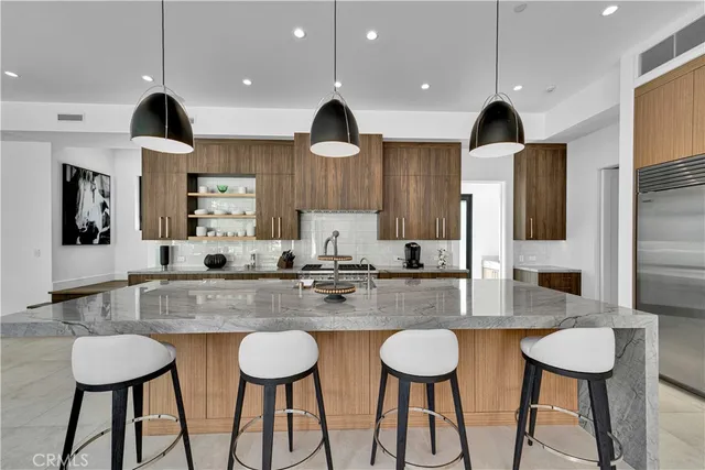 a kitchen with stainless steel appliances granite countertop a sink and a stove