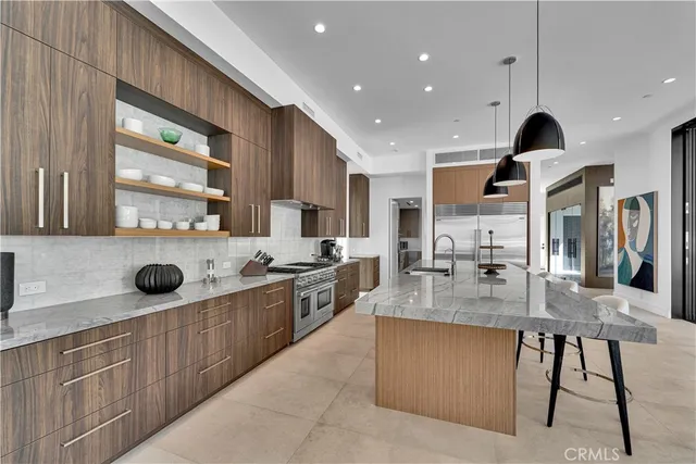 a large kitchen with stainless steel appliances lots of counter space and breakfast area