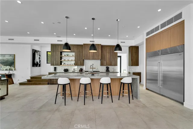 a group of people sitting in a kitchen