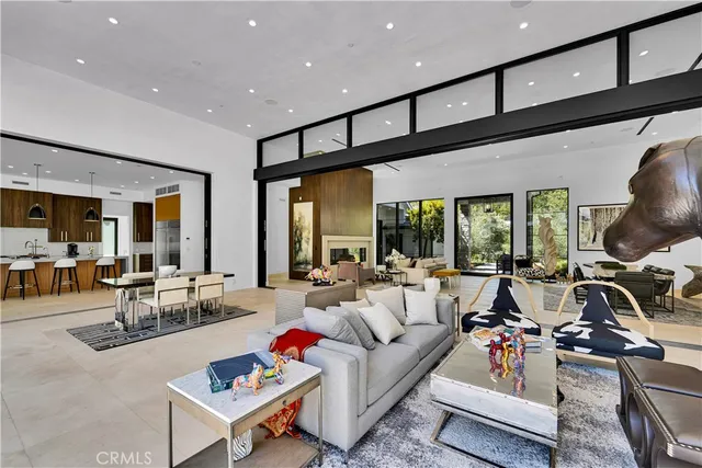 a living room with furniture gym equipment and a large window