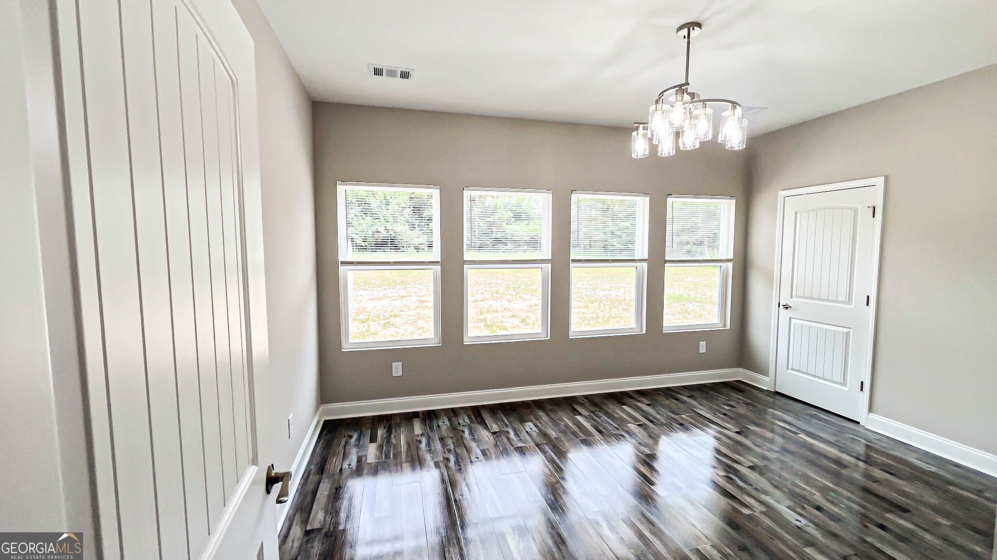 2011 Griffin Road Macon, GA 31216 - Photo 50 of 64 a view of an empty room with wooden floor and a window