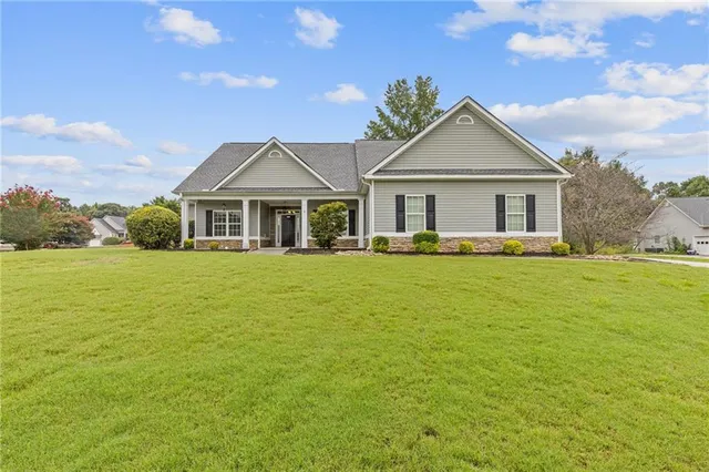 a front view of house with yard and green space