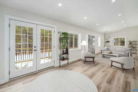 a living room with furniture and large windows