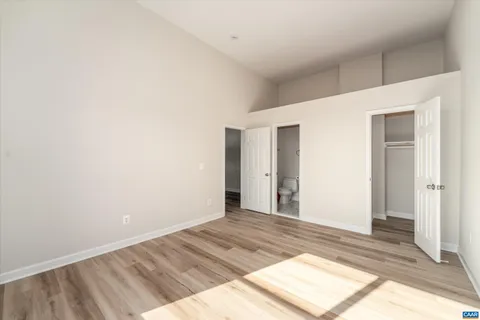 a view of a big room with wooden floor and bedroom