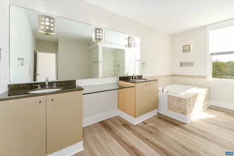 a kitchen with granite countertop a stove a sink and a refrigerator