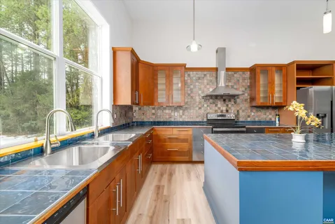 a kitchen with large windows and a sink