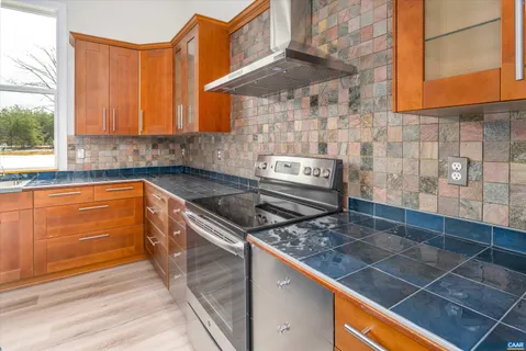 a kitchen with a sink a stove and cabinets