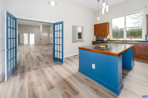 a kitchen with wooden floors sink and cabinets