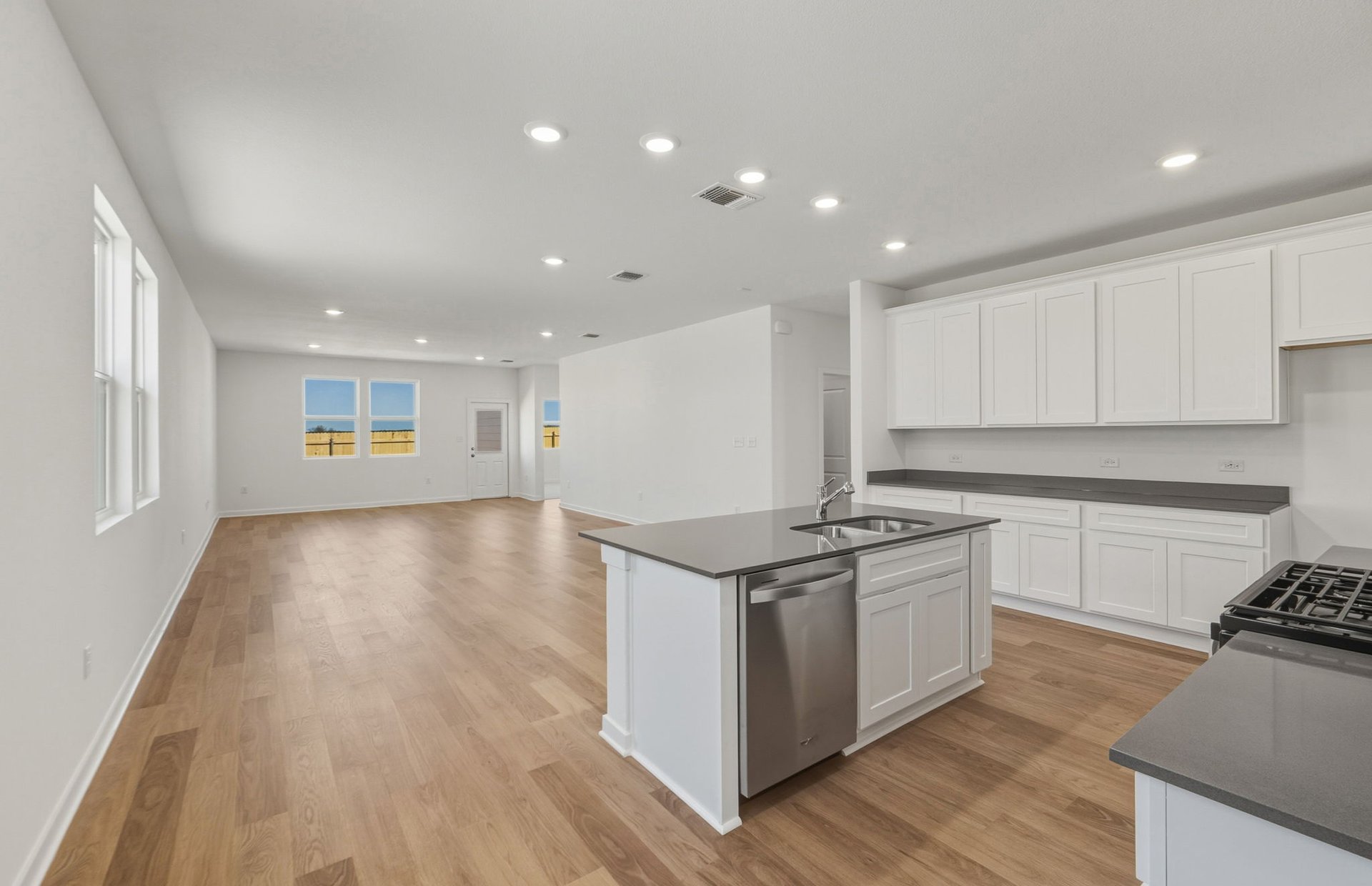104 Eagle Valley Drive Elgin, TX 78621 - Photo 3 of 18 a kitchen with stainless steel appliances granite countertop a stove and a refrigerator