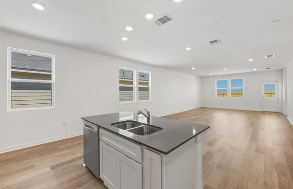 a kitchen with stainless steel appliances granite countertop a stove and a refrigerator