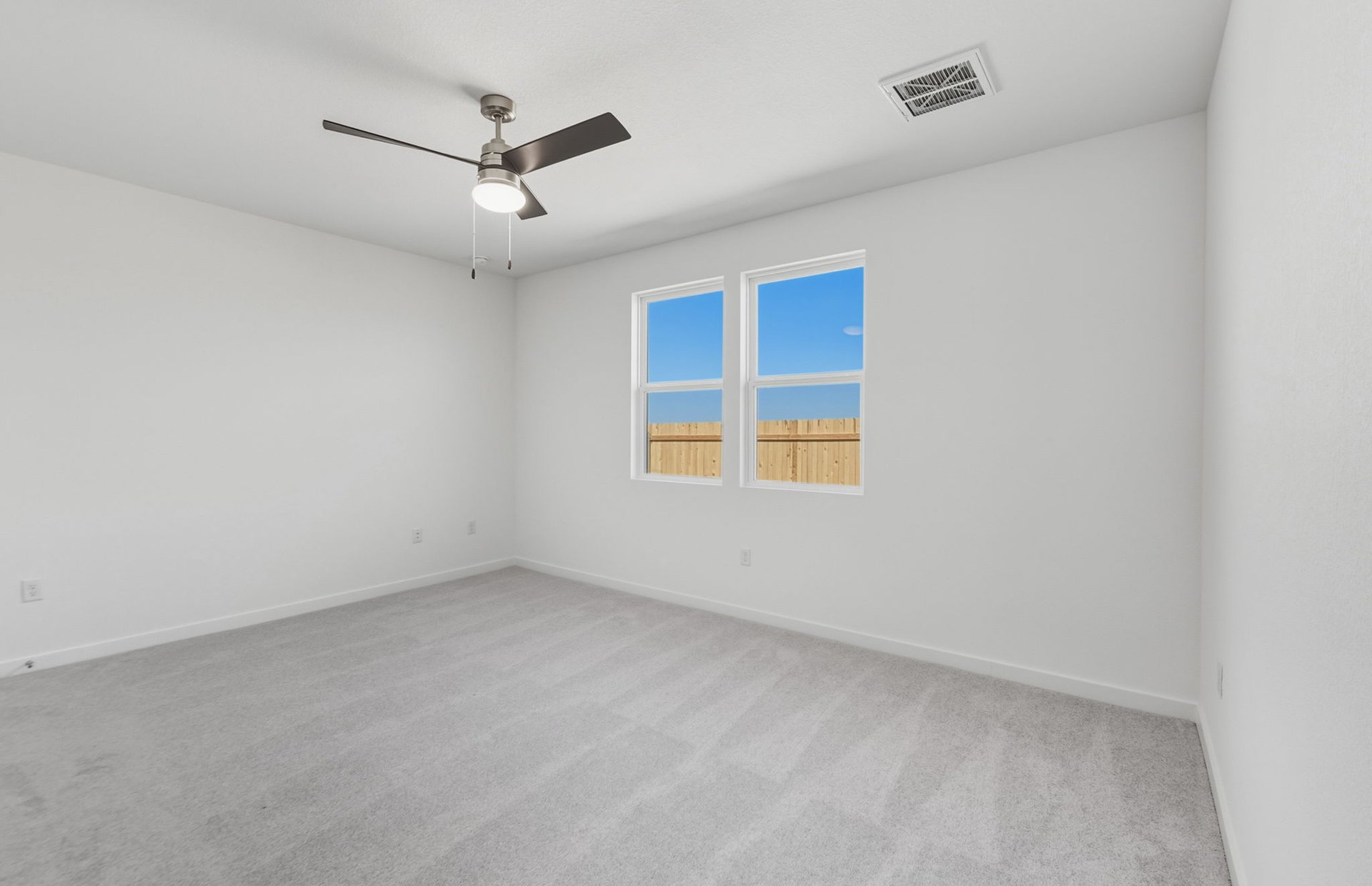 104 Eagle Valley Drive Elgin, TX 78621 - Photo 7 of 18 an empty room with ceiling fan and windows