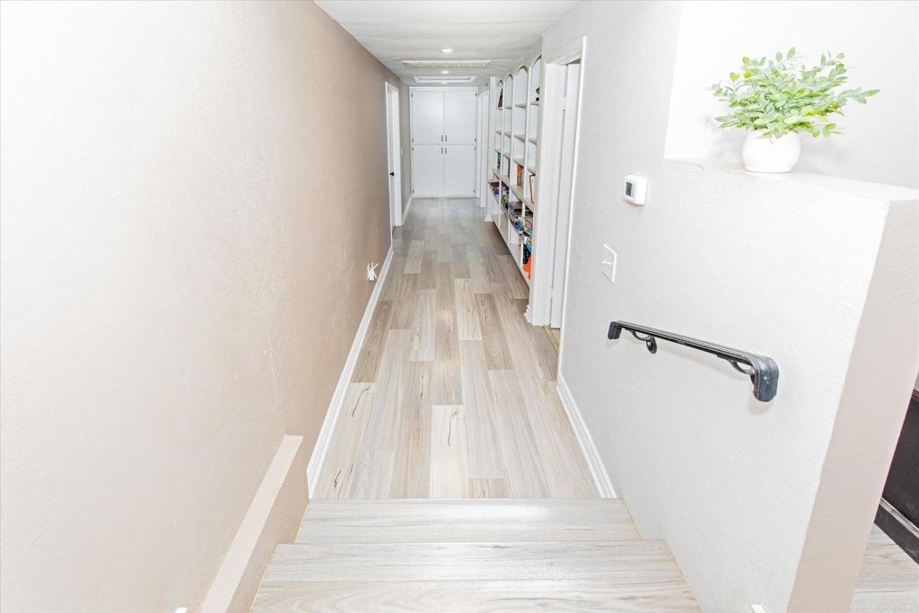 24093 Sargeant Road Ramona, CA 92065 - Photo 14 of 57 a view of a hallway with wooden floor and staircase