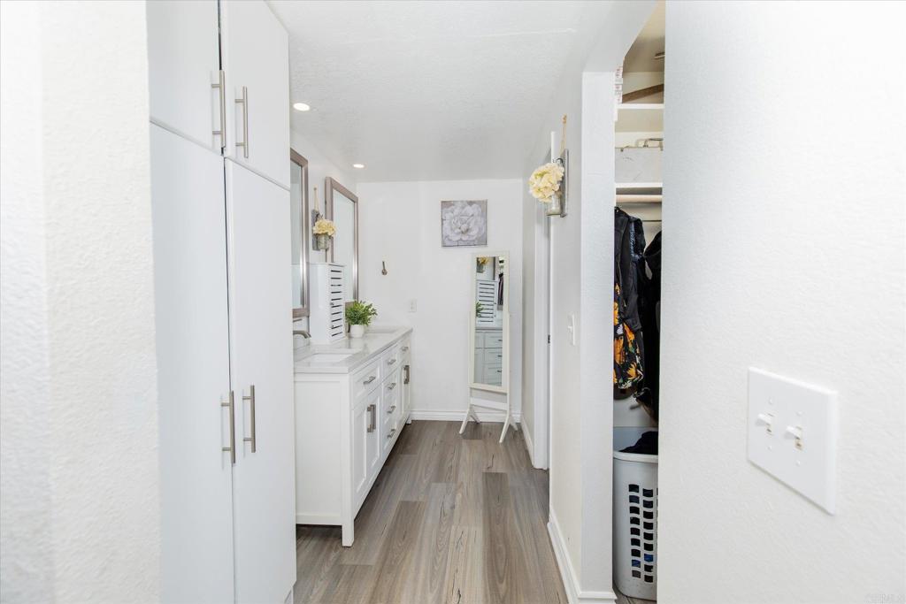 24093 Sargeant Road Ramona, CA 92065 - Photo 21 of 57 a view of a hallway with wooden floor and staircase