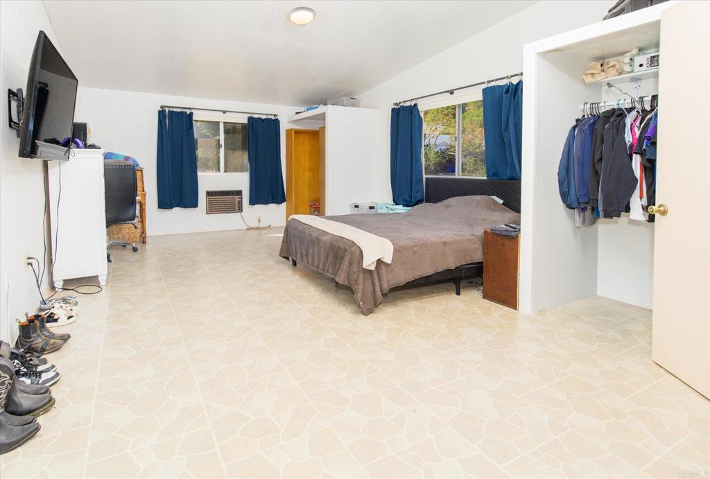 24093 Sargeant Road Ramona, CA 92065 - Photo 28 of 57 a spacious bedroom with a bed and a walk in closet