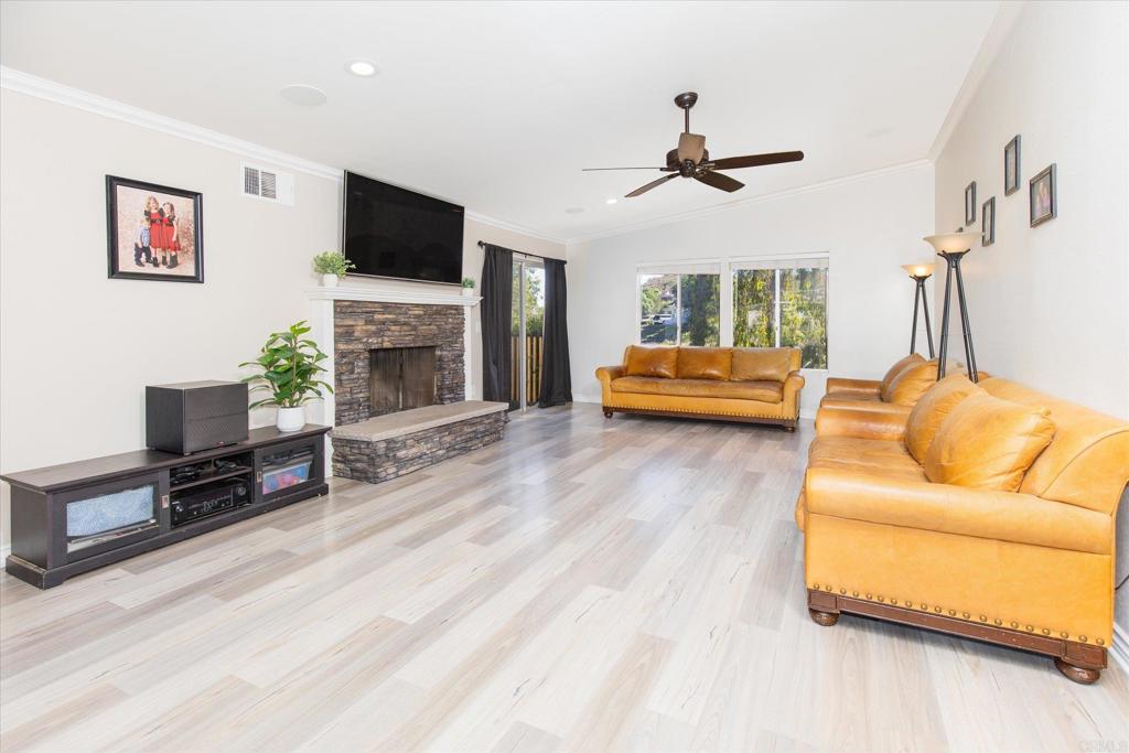 24093 Sargeant Road Ramona, CA 92065 - Photo 3 of 57 a living room with furniture a fireplace and a flat screen tv