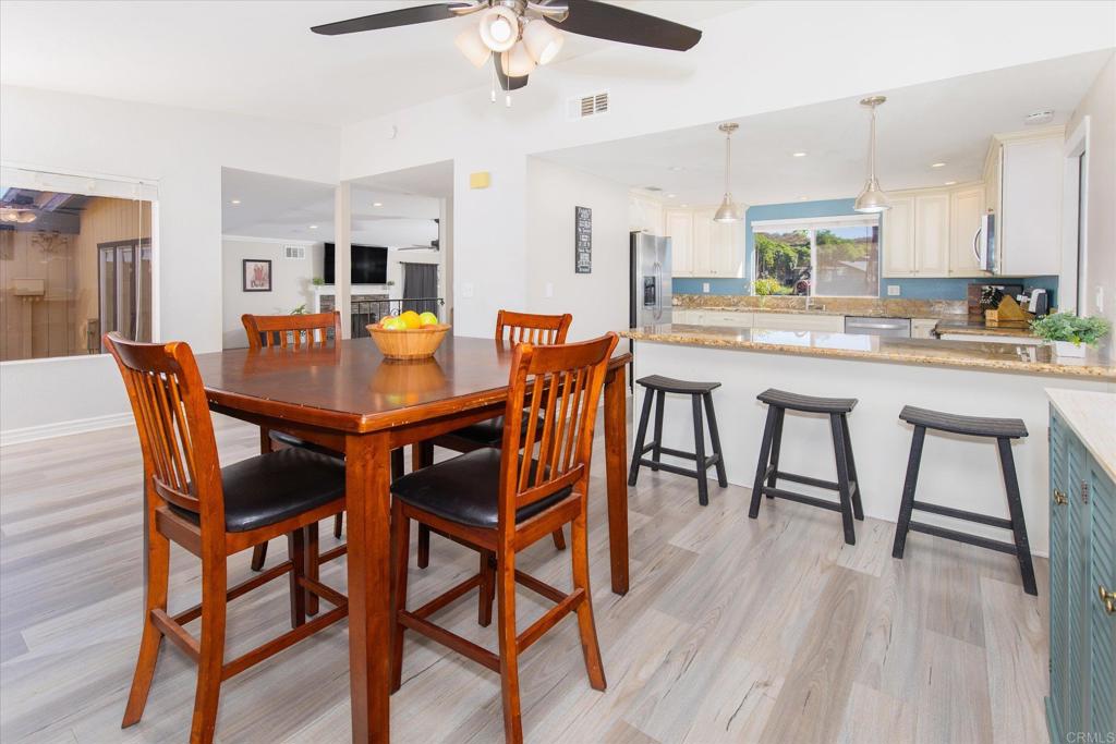24093 Sargeant Road Ramona, CA 92065 - Photo 8 of 57 a dining room with a wooden table and chairs