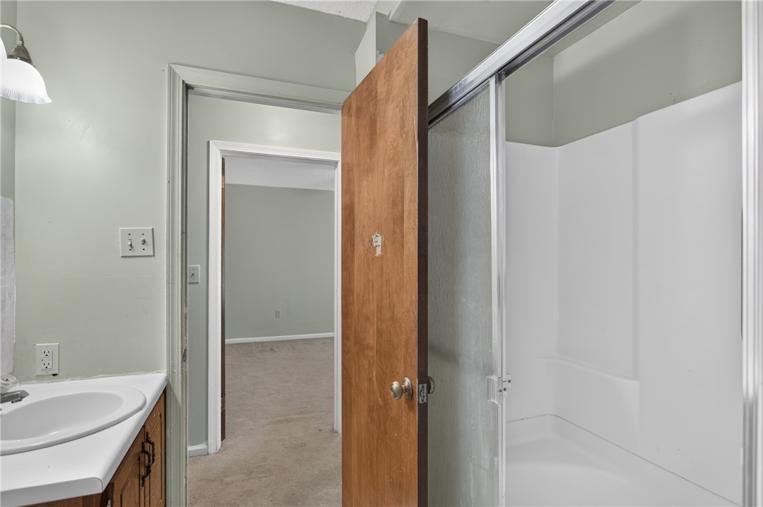 1412 Simpson Road Pendleton, SC 29670 - Photo 27 of 48 Well-maintained vanity area with functional sink, adjacent to a practical shower stall.