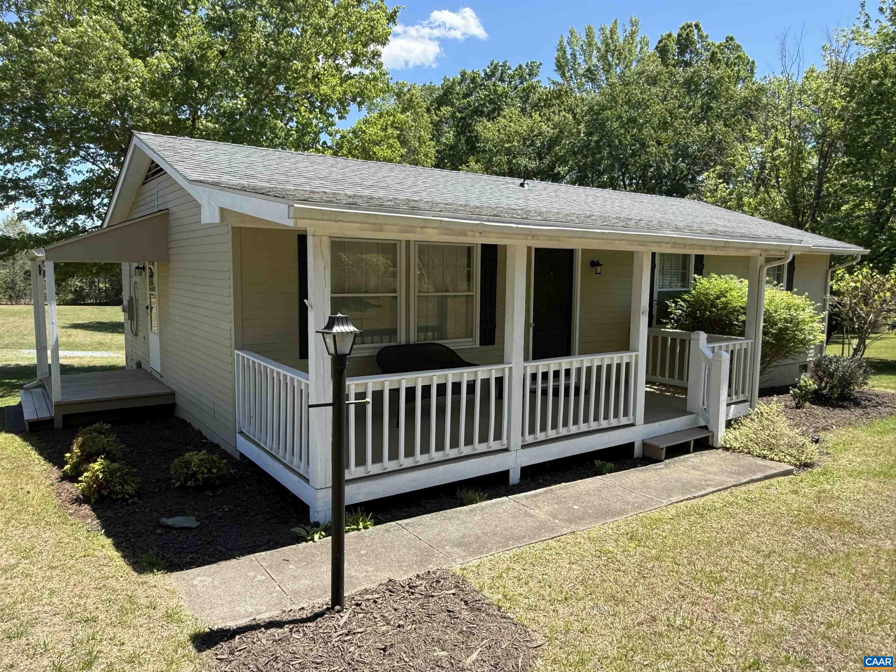 2002 Oliver Creek Road Troy, VA 22974 - Photo 23 of 38 a view of a house with a wooden deck and a yard
