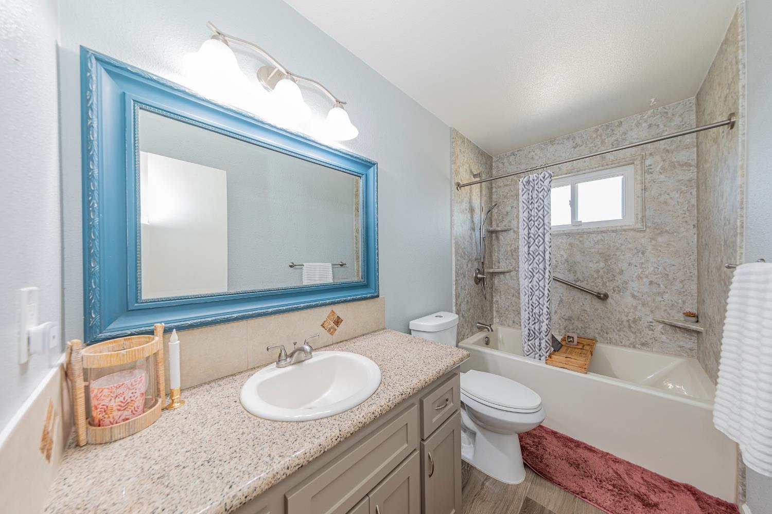 47165 Modoc Road Coarsegold, CA 93614 - Photo 14 of 33 a bathroom with a granite countertop sink toilet mirror and bathtub