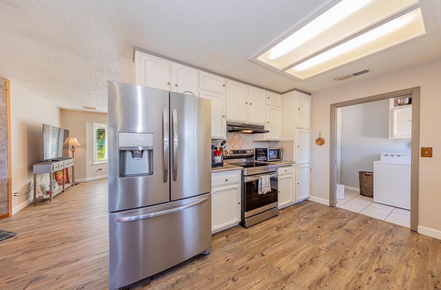 47165 Modoc Road Coarsegold, CA 93614 - Photo 2 of 33 a kitchen with stainless steel appliances a refrigerator stove microwave and cabinets