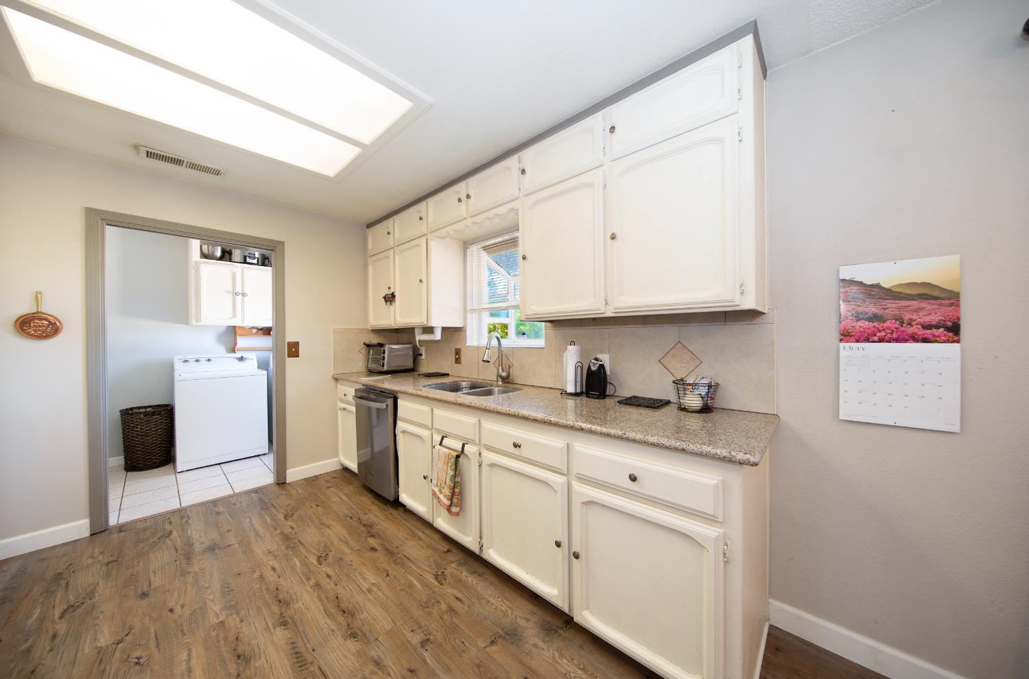 47165 Modoc Road Coarsegold, CA 93614 - Photo 3 of 33 a kitchen with granite countertop white cabinets and white appliances