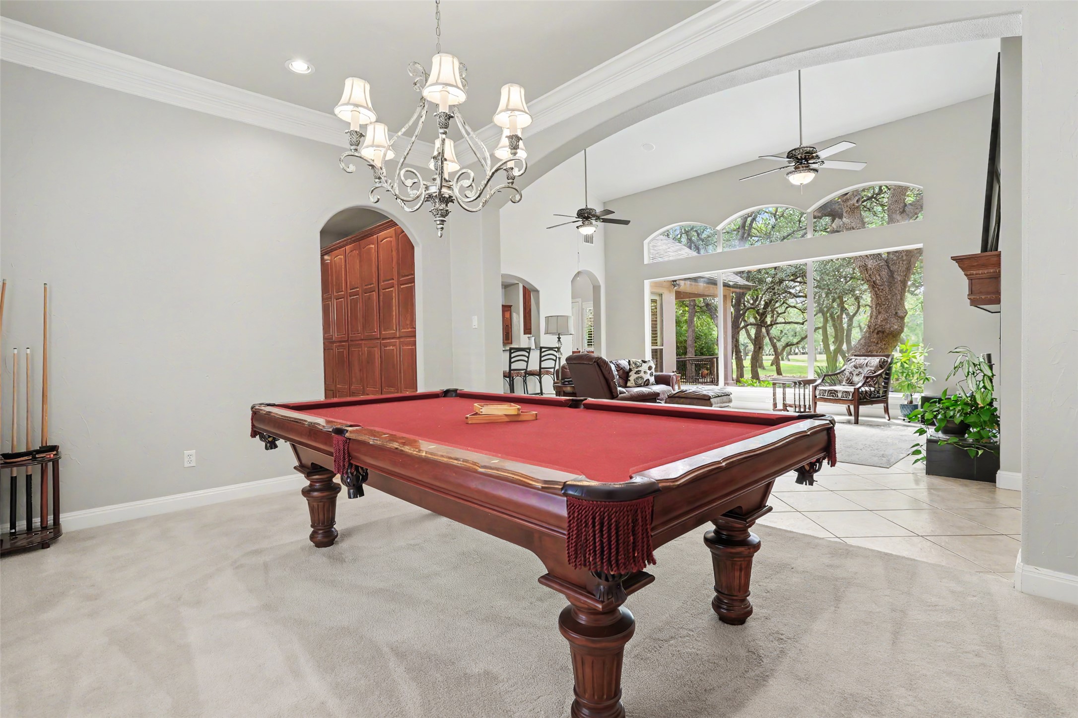33 Meadows End Georgetown, TX 78628 - Photo 28 of 40 A spacious game room features a billiard table, a vaulted ceiling, and an open layout to a living area.