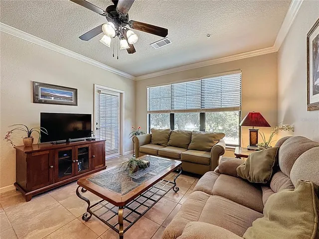 a living room with furniture a large window and a flat screen tv