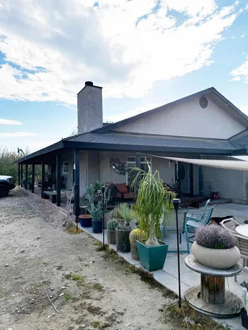 a view of a chair and tables in patio