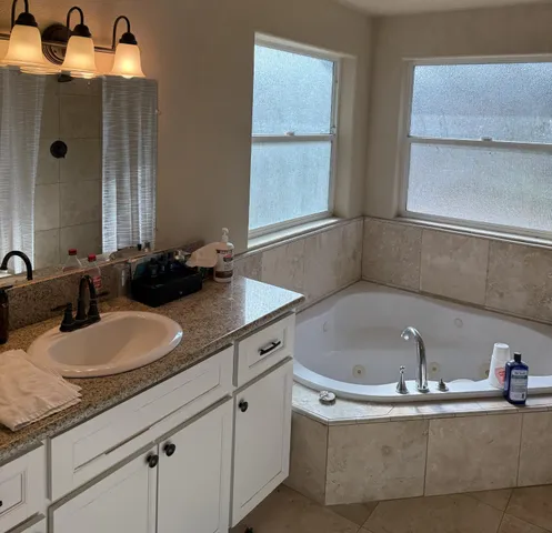 a bath tub sitting next to a bathroom sink