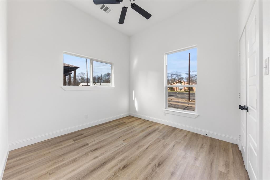 1247 Bonham Street Paris, TX 75460 - Photo 12 of 18 wooden floor in an empty room with a window