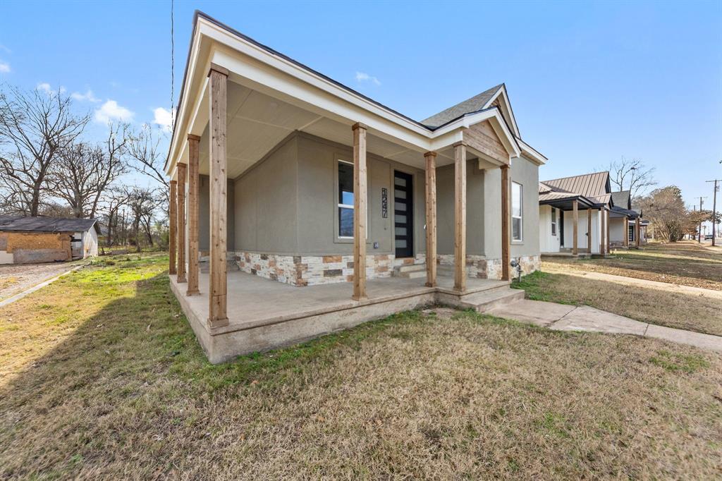 1247 Bonham Street Paris, TX 75460 - Photo 17 of 18 front view of a house with a yard