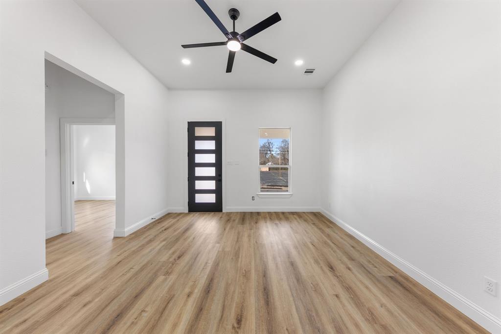 1247 Bonham Street Paris, TX 75460 - Photo 4 of 18 wooden floor in an empty room with a window