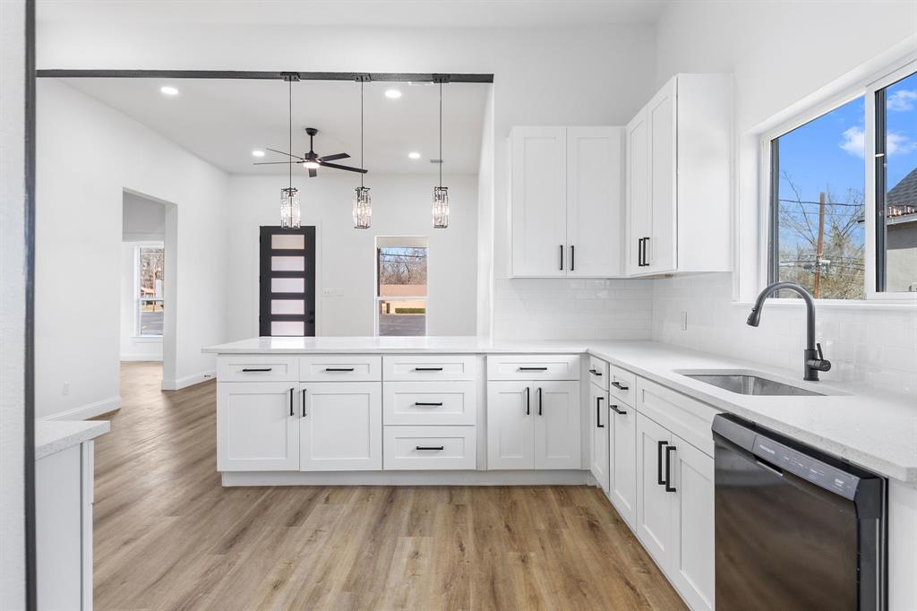 1247 Bonham Street Paris, TX 75460 - Photo 7 of 18 a kitchen with stainless steel appliances white cabinets and a sink