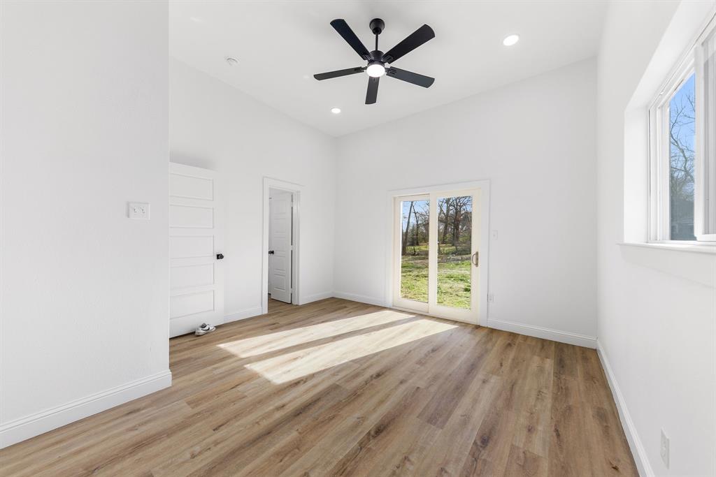 1247 Bonham Street Paris, TX 75460 - Photo 8 of 18 an empty room with wooden floor and windows