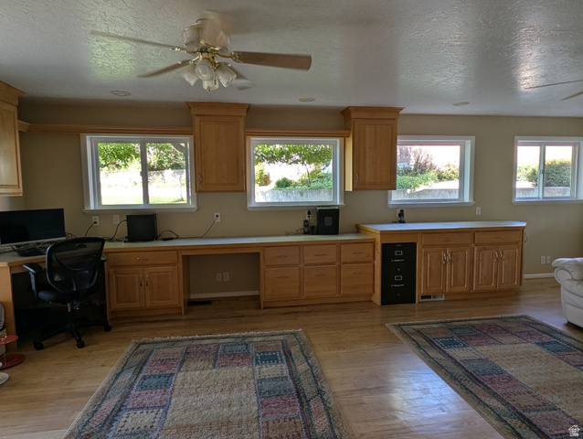 1411 Millbrook Way Bountiful, UT 84010 - Photo 15 of 36 Spacious room featuring multiple windows, extensive built-in cabinetry, wood-finish flooring, a ceiling fan, and recessed lighting