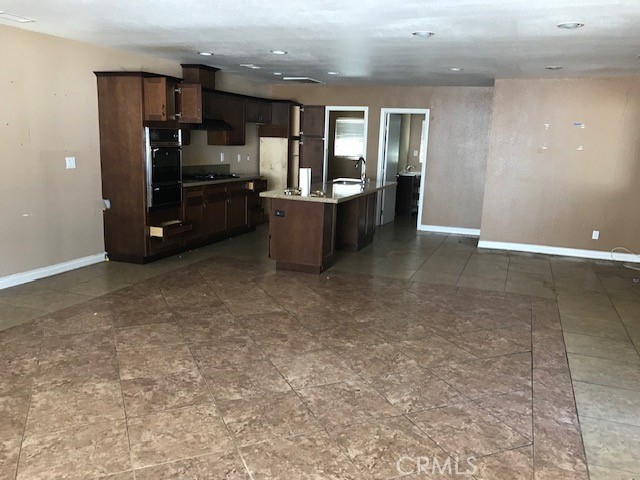 16239 Chicago Avenue Bellflower, CA 90706 - Photo 11 of 30 an empty room with furniture and wooden floors