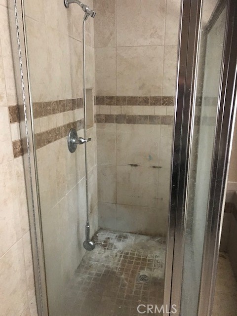 16239 Chicago Avenue Bellflower, CA 90706 - Photo 18 of 30 a bathroom with a glass shower door