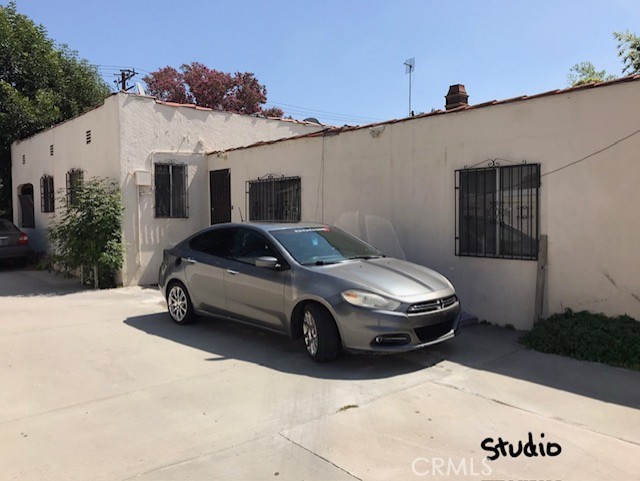 16239 Chicago Avenue Bellflower, CA 90706 - Photo 26 of 30 a car parked in front of a white house