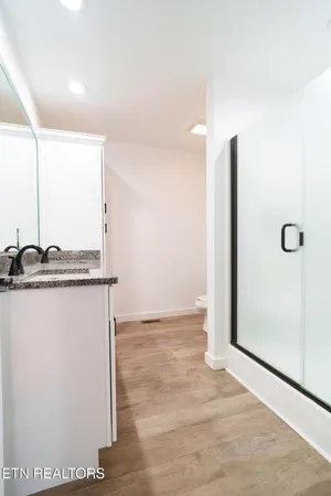 a view of a room with wooden floor