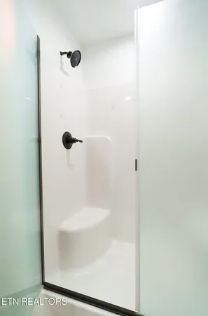 a bathroom with a glass shower door