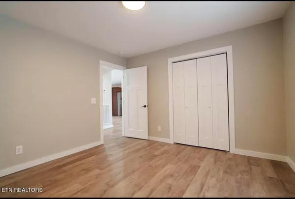 a view of an empty room and wooden floor