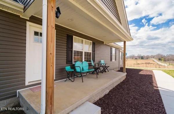 a swimming pool with outdoor seating and yard