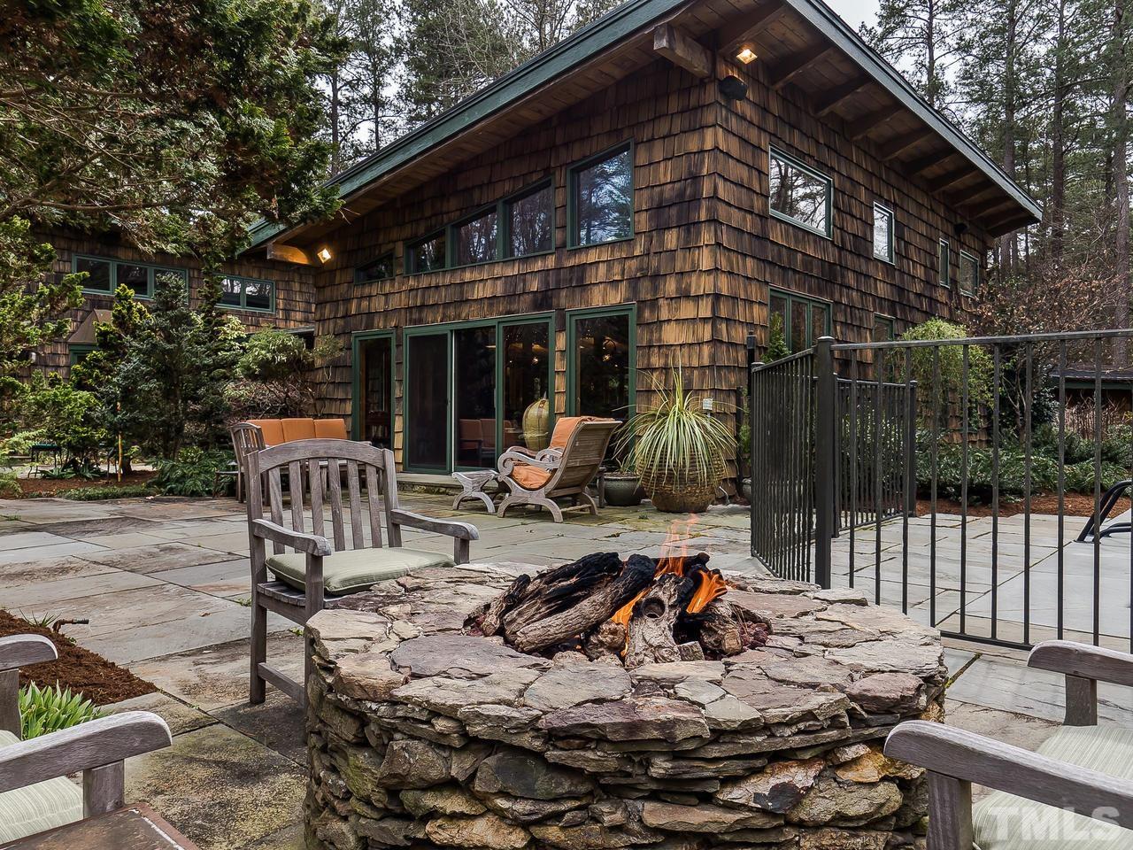Family room with custom built-ins overlooking private pond and pool.