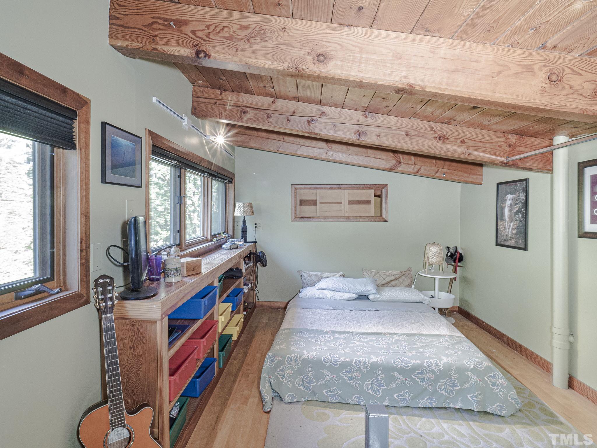 3916 Cole Mill Road Durham, NC 27712 - Photo 9 of 30 Sleeping loft accessible through spiral staircase that would be counted as a bedroom if the ceiling height was within square footage guidelines.