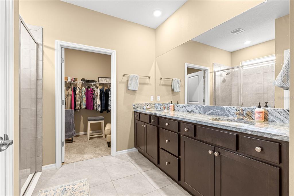 6365 Southwest 88th Loop Ocala, FL 34476 - Photo 18 of 35 a spacious bathroom with a double vanity sink and a mirror