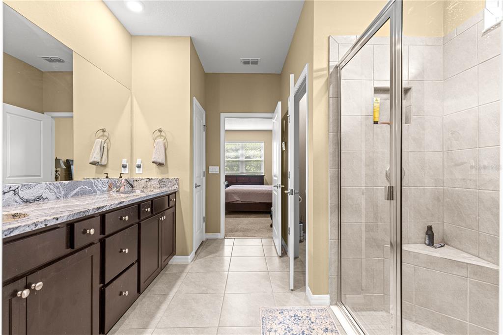 6365 Southwest 88th Loop Ocala, FL 34476 - Photo 19 of 35 a en suite bathroom with a granite countertop sink and a mirror