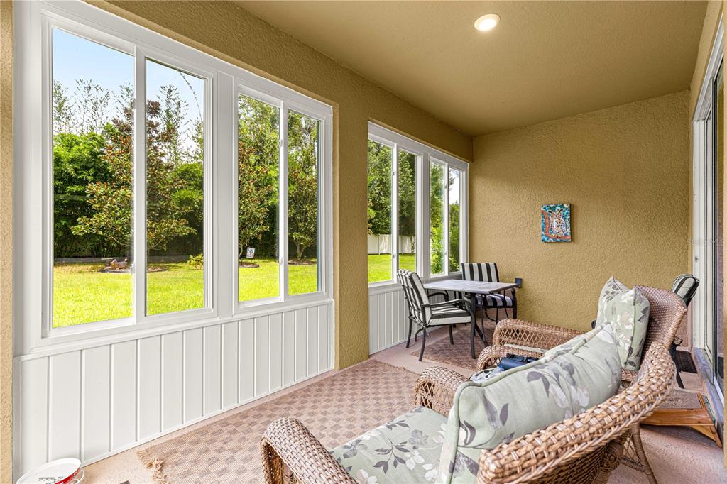 6365 Southwest 88th Loop Ocala, FL 34476 - Photo 28 of 35 a view of a dining room with furniture large windows and wooden floor